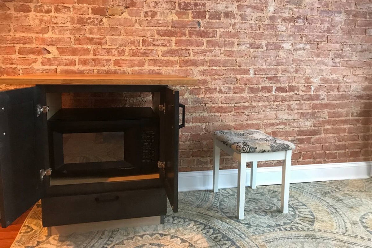 Butcher block desk, Exposed brick walls.