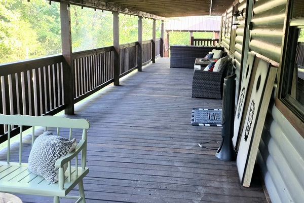 Look at this enormous covered front porch with multiple areas to hang out.