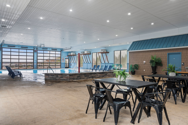 Indoor pool. Heated, and fun kid friendly features. Bathrooms, lounge chairs, and dining tables. Open year round.