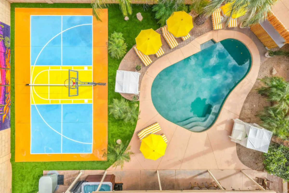 Straight-down drone view captures the pool and sport court.