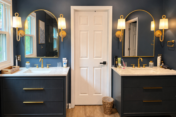 Spacious primary bathroom with dual vanities, warm lighting and plenty of room to get ready.