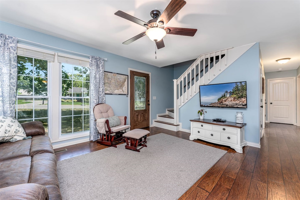 Living room with large windows and 55" Roku tv