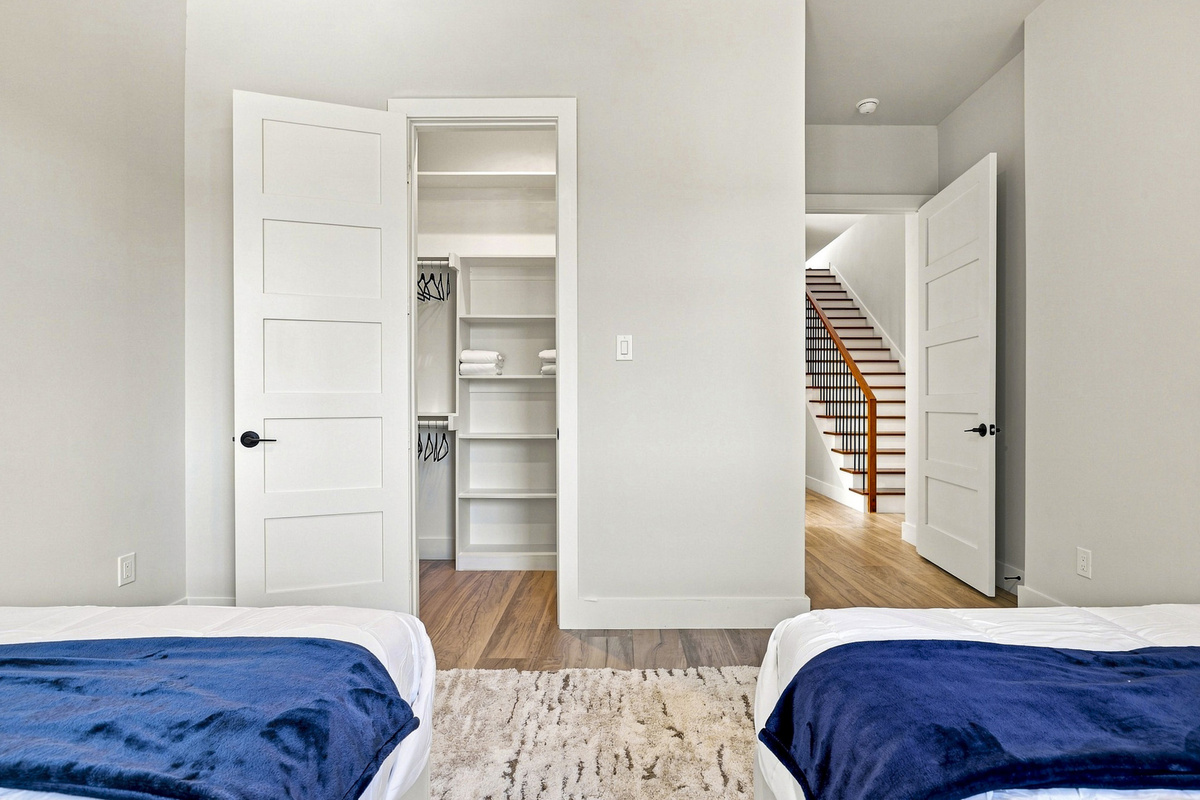Modern elegance awaits with twin beds, natural light, and spacious closet access!