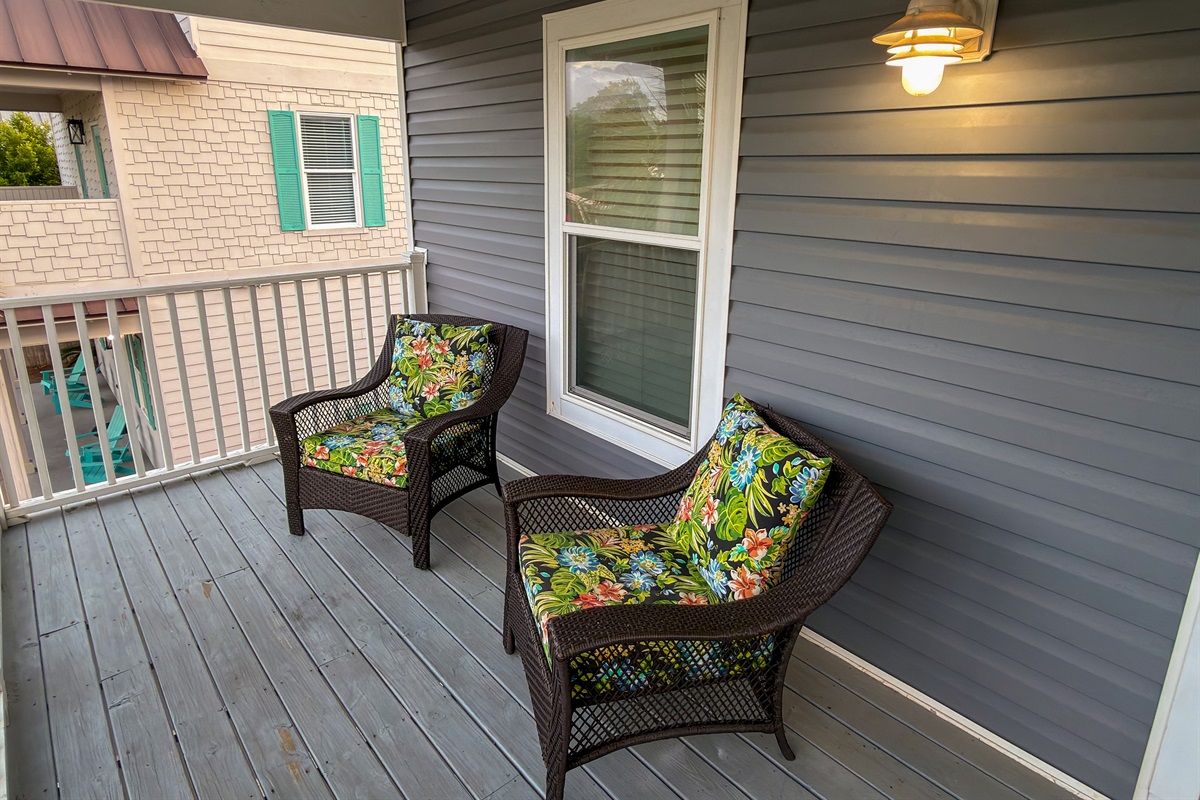 Soft evening light and gentle ocean breezes make this private balcony an inviting place to linger long after the sun goes down.