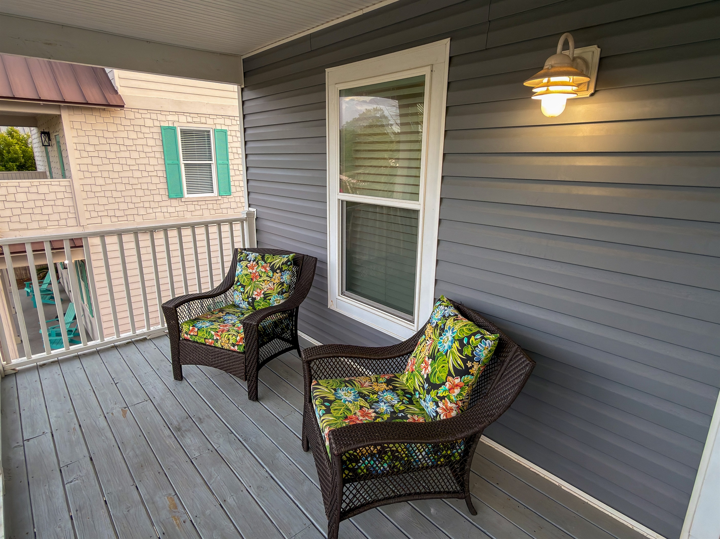 Soft evening light and gentle ocean breezes make this private balcony an inviting place to linger long after the sun goes down.
