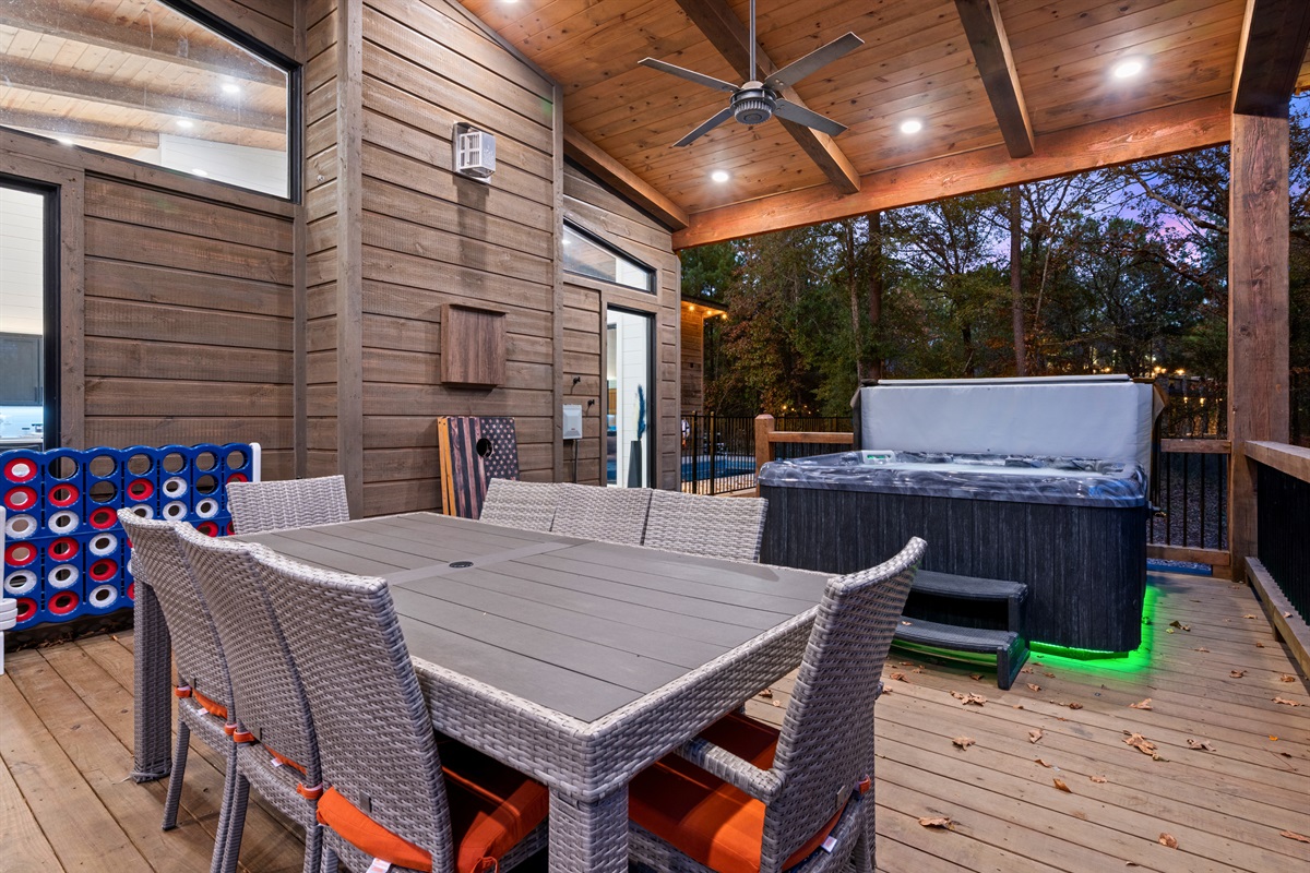 The back deck dining setup is great for group meals, card games, or just enjoying the sights and sounds of nature.