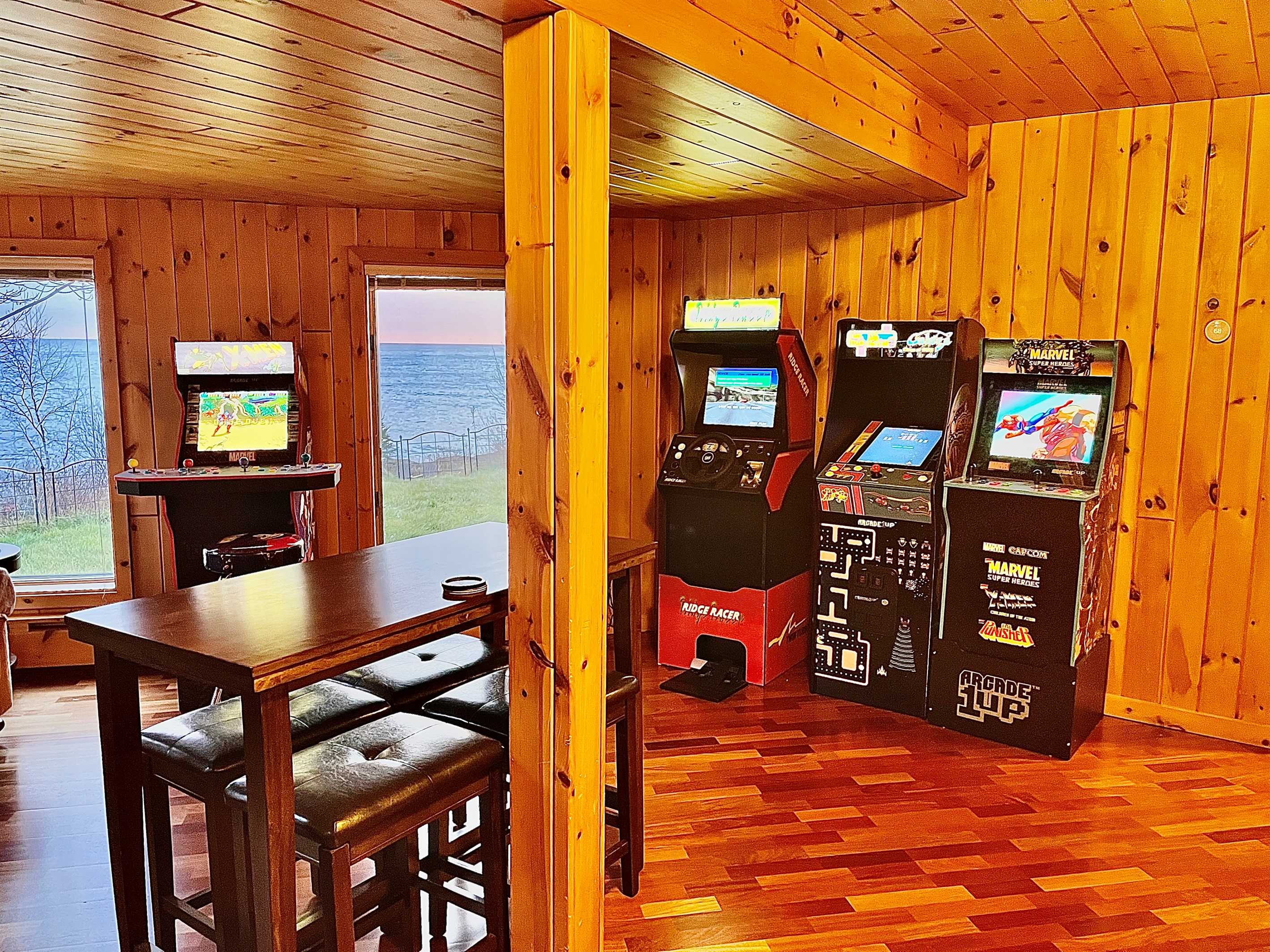 Kick back and enjoy a blast of nostalgia! This section of the game room brings together classics like Ridge Racer, Ms. Pac-Man/Galaga, and Marvel vs. Capcom, creating the perfect spot for friendly competition and late-night fun all with views of the lake!