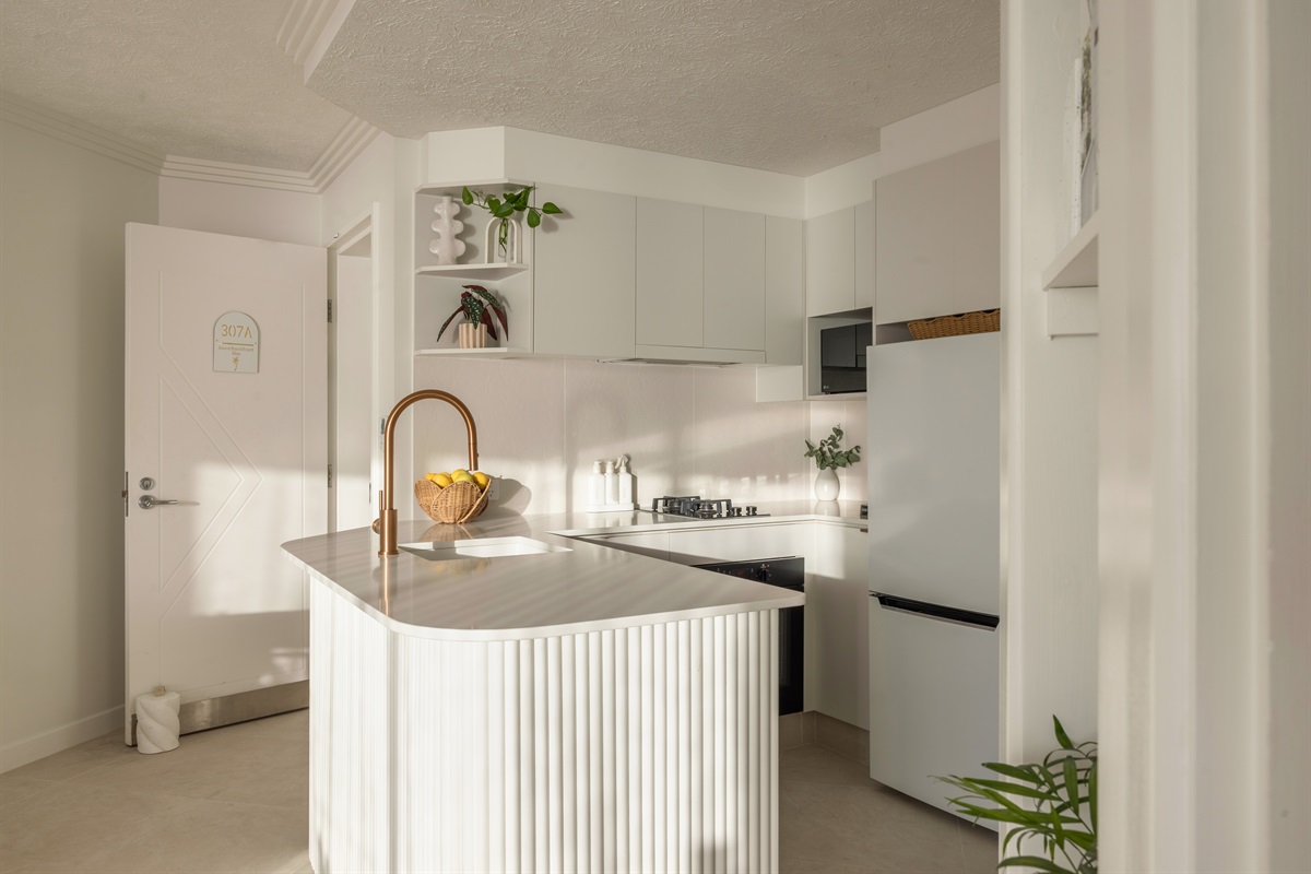 Freshly renovated kitchen with thoughtful coastal styling & modern comforts.