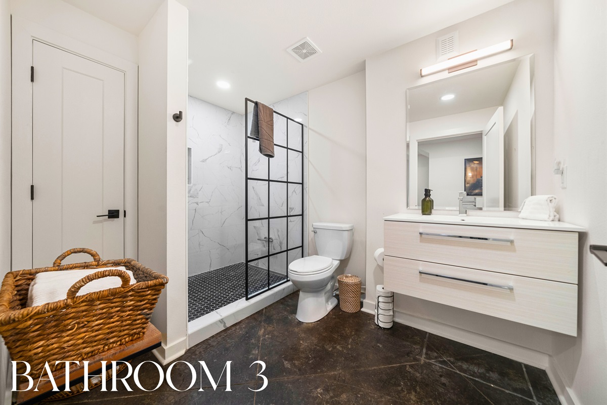 Bathroom 3: Stylish and spacious with walk-in shower, bright lighting, and modern design.
