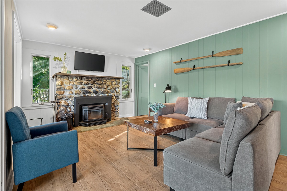 Cozy living room seating around the fireplace.