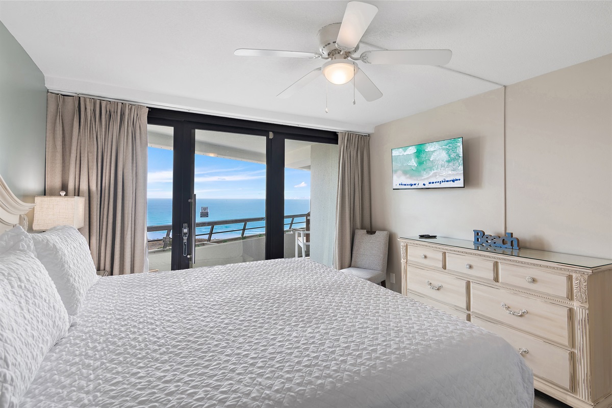 Primary bedroom which features Gulf Views, King Bed, Smart TV, Patio Access, and Private, REMODELED bathroom with walk in shower and dual vanity!