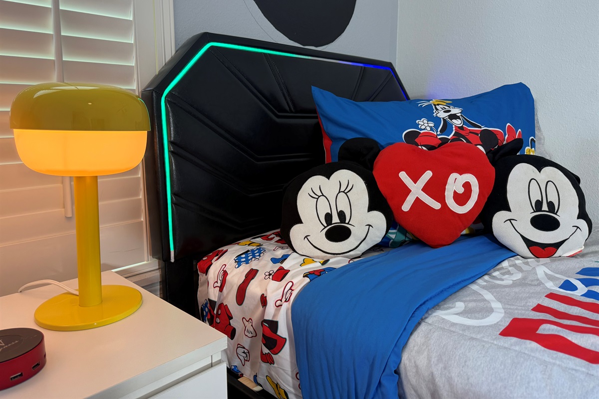 🛏️ Comfort meets magic – relax in our Mickey Mouse-themed twin room with a 50” Smart TV for endless fun.