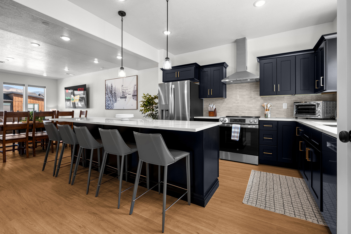 Gather in the heart of Powderline Lodge, where the spacious kitchen island and open layout make meals and conversation easy.