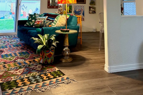 2nd living room with large smart tv & sofa that has a queen pull out bed.