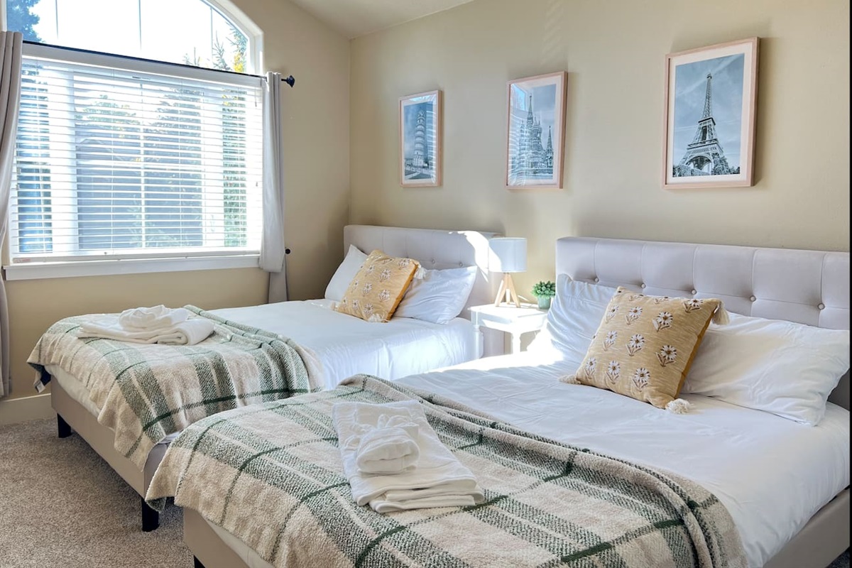 This bedroom has 2 full-sized beds.