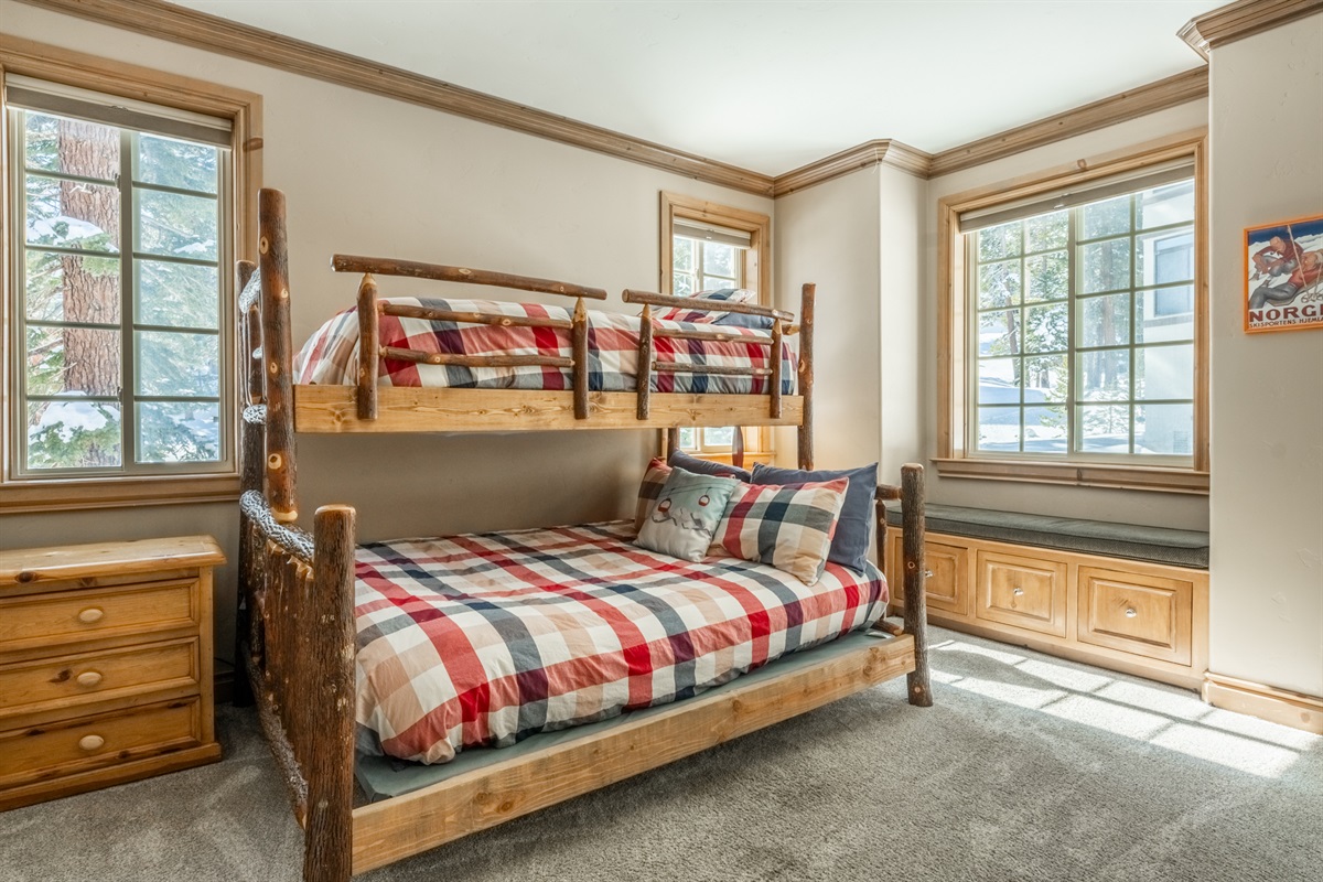 The, light-filled bunkroom offers a cozy window seat and warm natural light from south- and west-facing windows—designed for flexible sleeping and relaxed lounging.