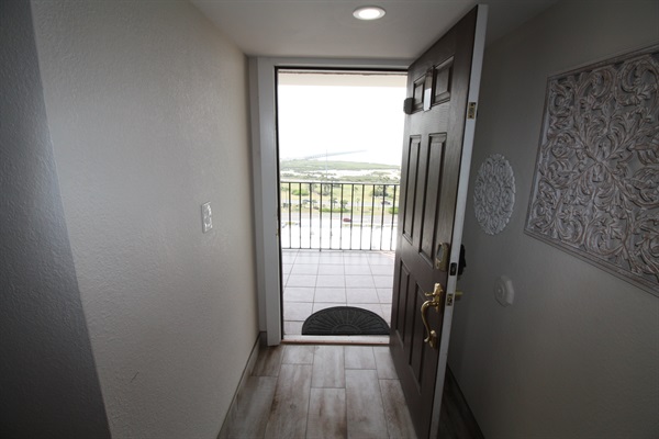 Front door opens to walkway overlooking the bay and bridge.