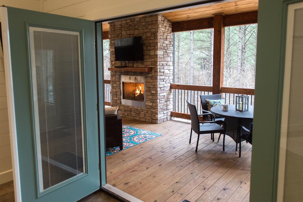 Main Bedroom: Step outside to your private retreat with a fireplace and serene woodland views!