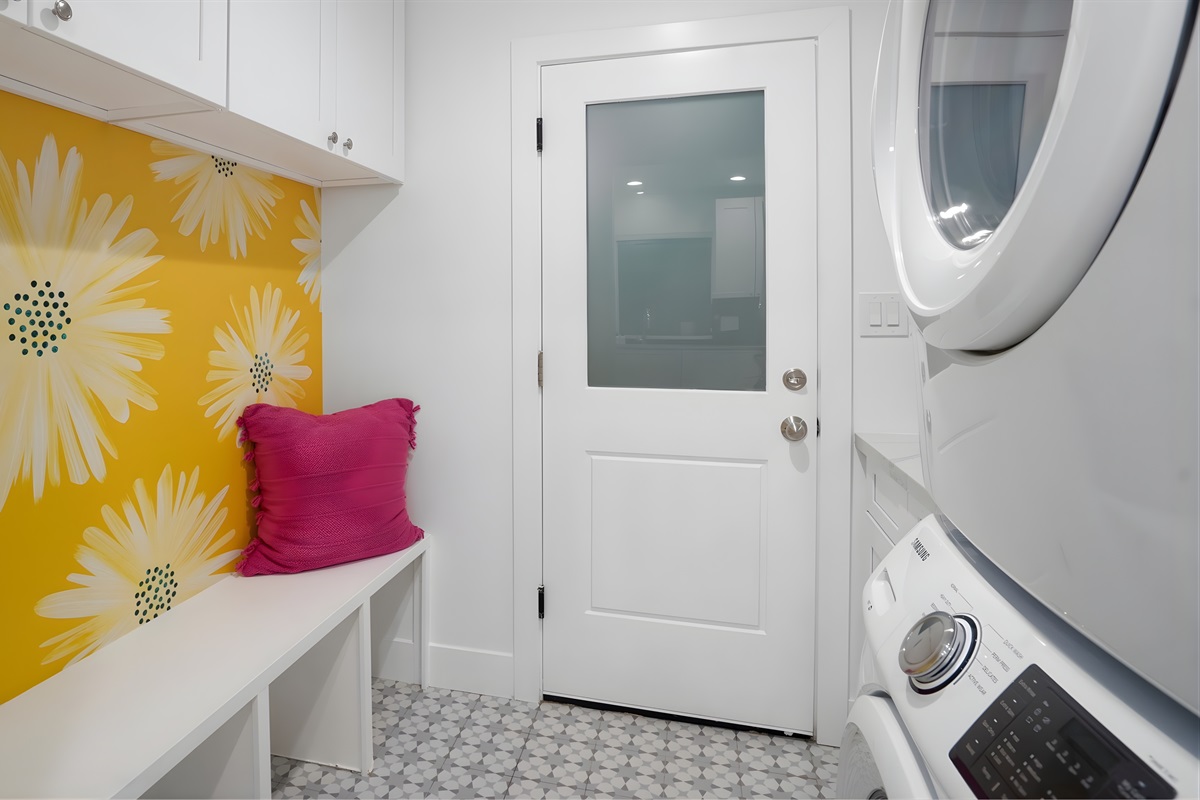 Laundry room with washer/dryer, sink, bench seating, and tons of storage