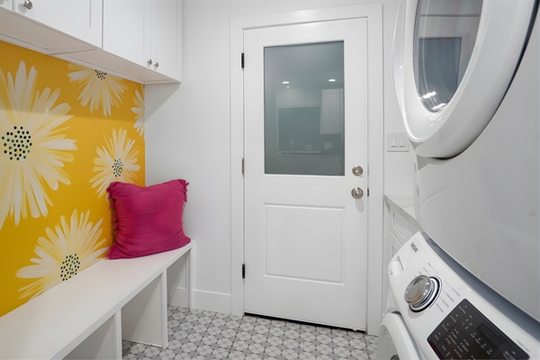 Laundry room with washer/dryer, sink, bench seating, and tons of storage