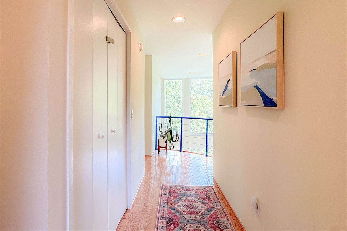 Upstairs hallway leading to upstairs bedroom 2. The balcony overlook is a wonderful touch to the property.