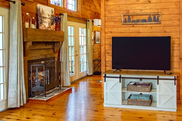 Inviting living room with vaulted ceilings, cozy fireplace, and Smart TV