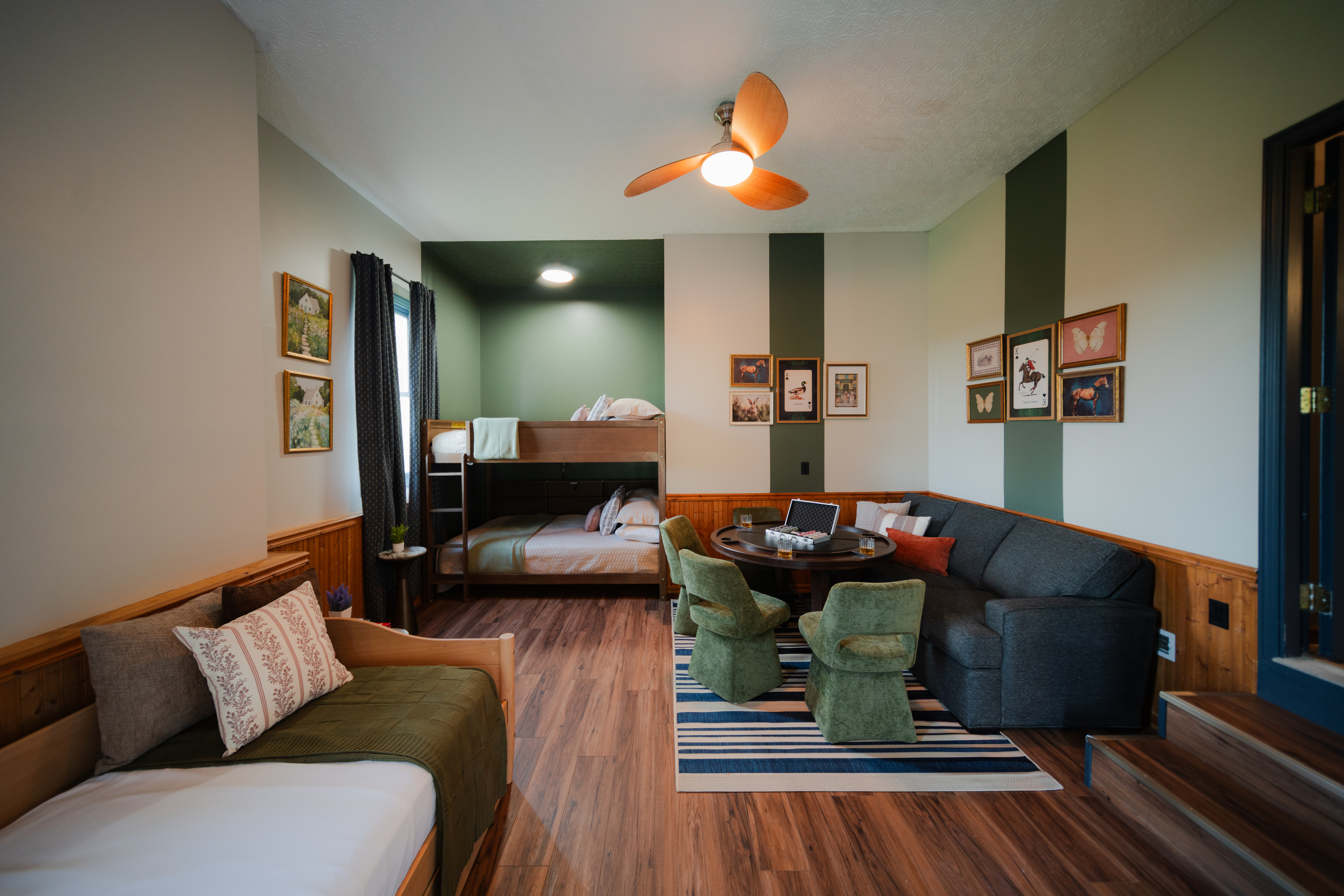 Sleep, play, and unwind in a room featuring queen bunk beds, a twin bed, and a cozy gaming nook