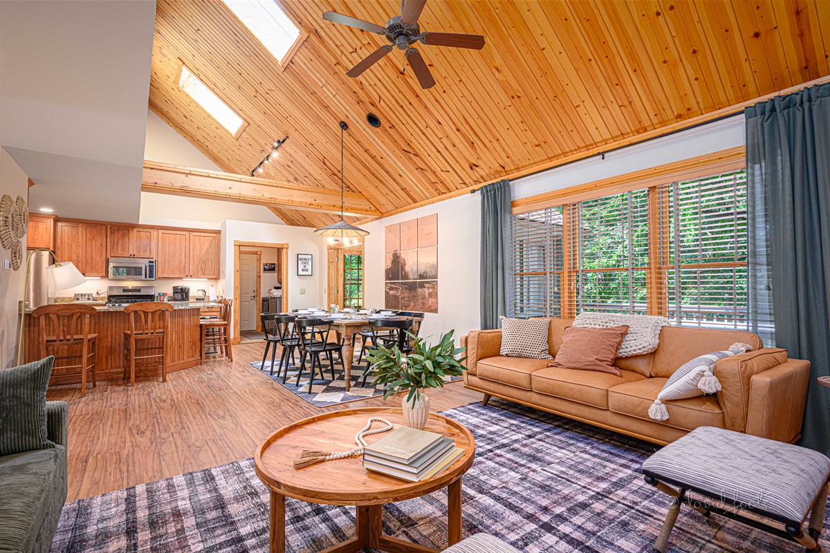 Open kitchen/dining/living room with vaulted ceiling for catching up with family and friends