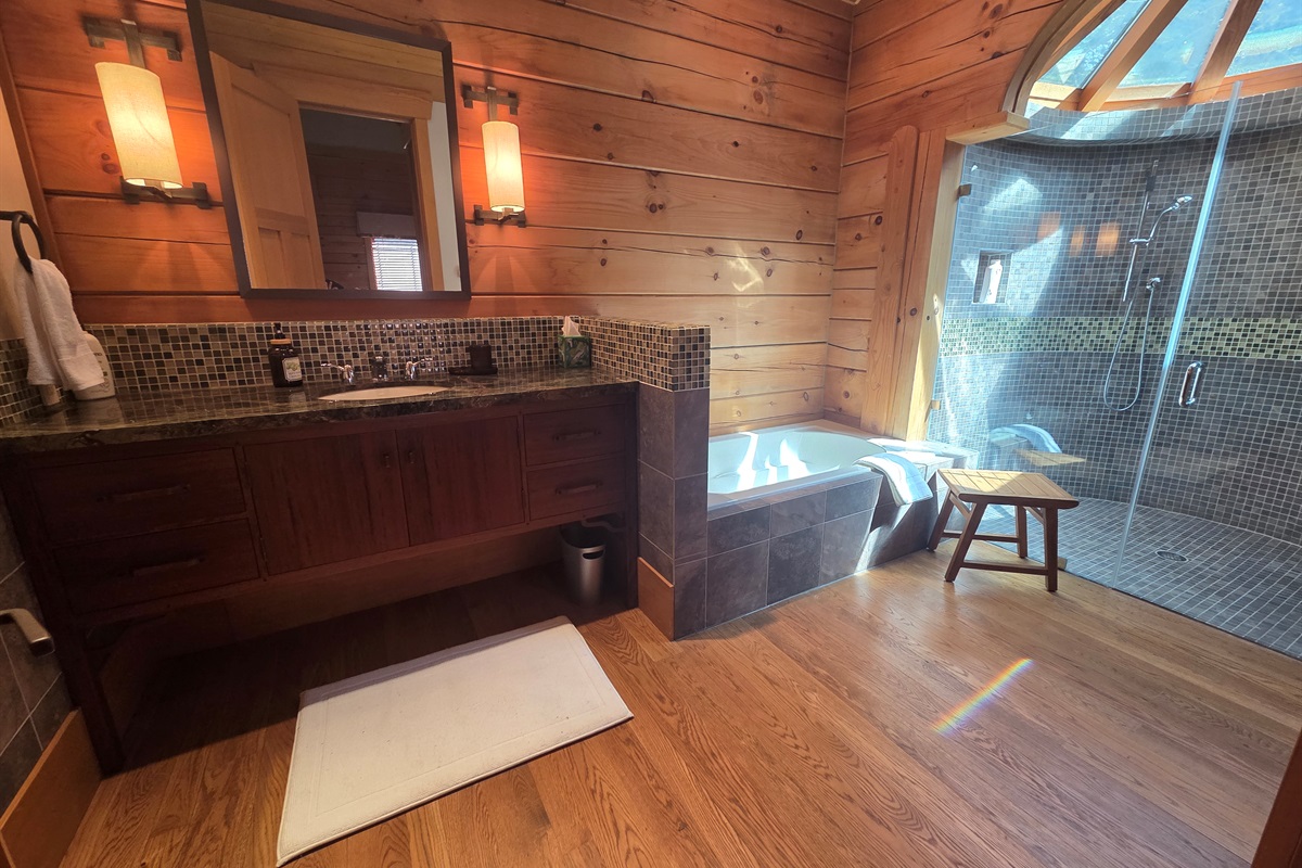 Spa-like second bedroom bathroom with a soaking tub and a large walk-in shower.