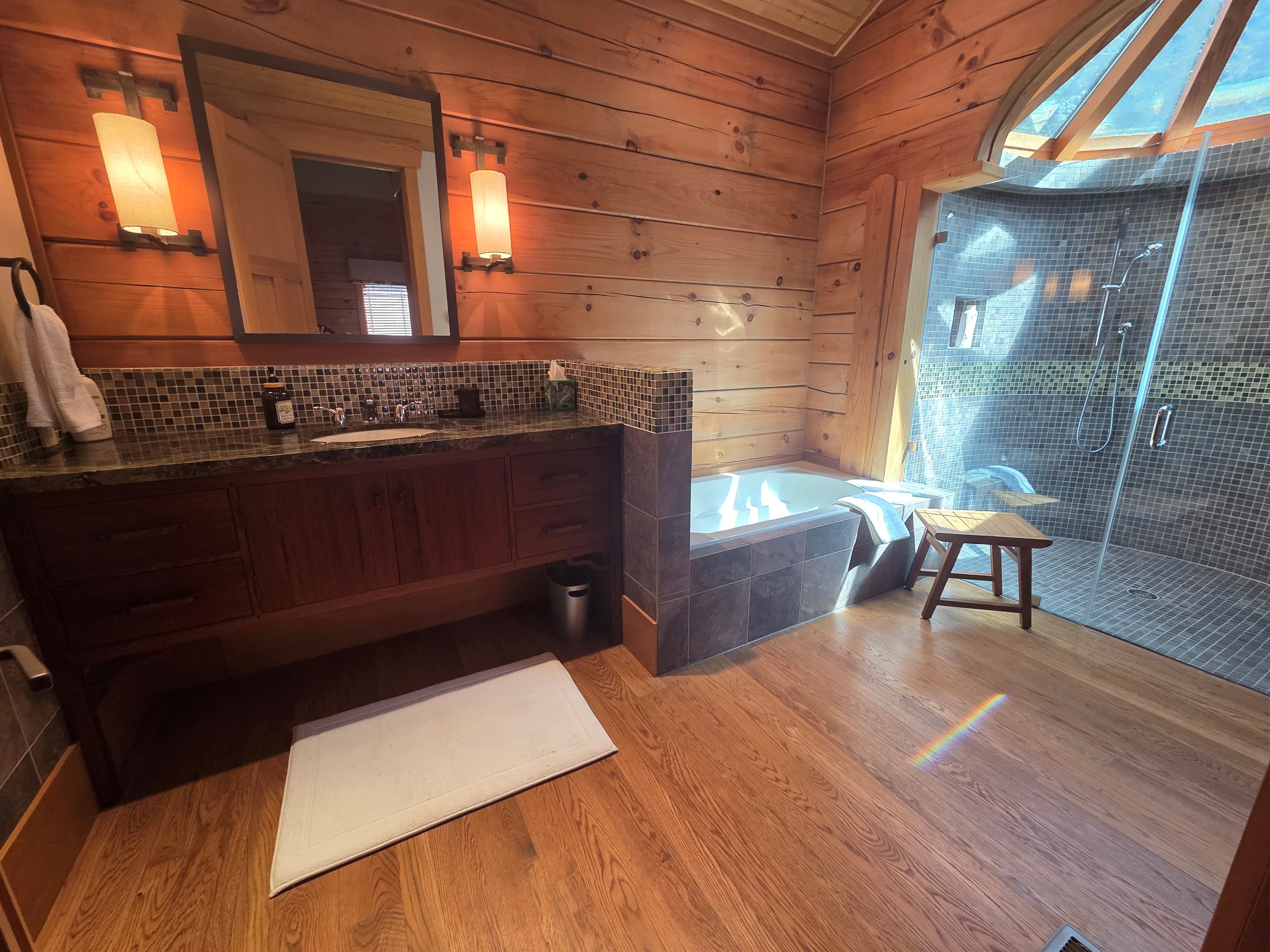 Spa-like second bedroom bathroom with a soaking tub and a large walk-in shower.