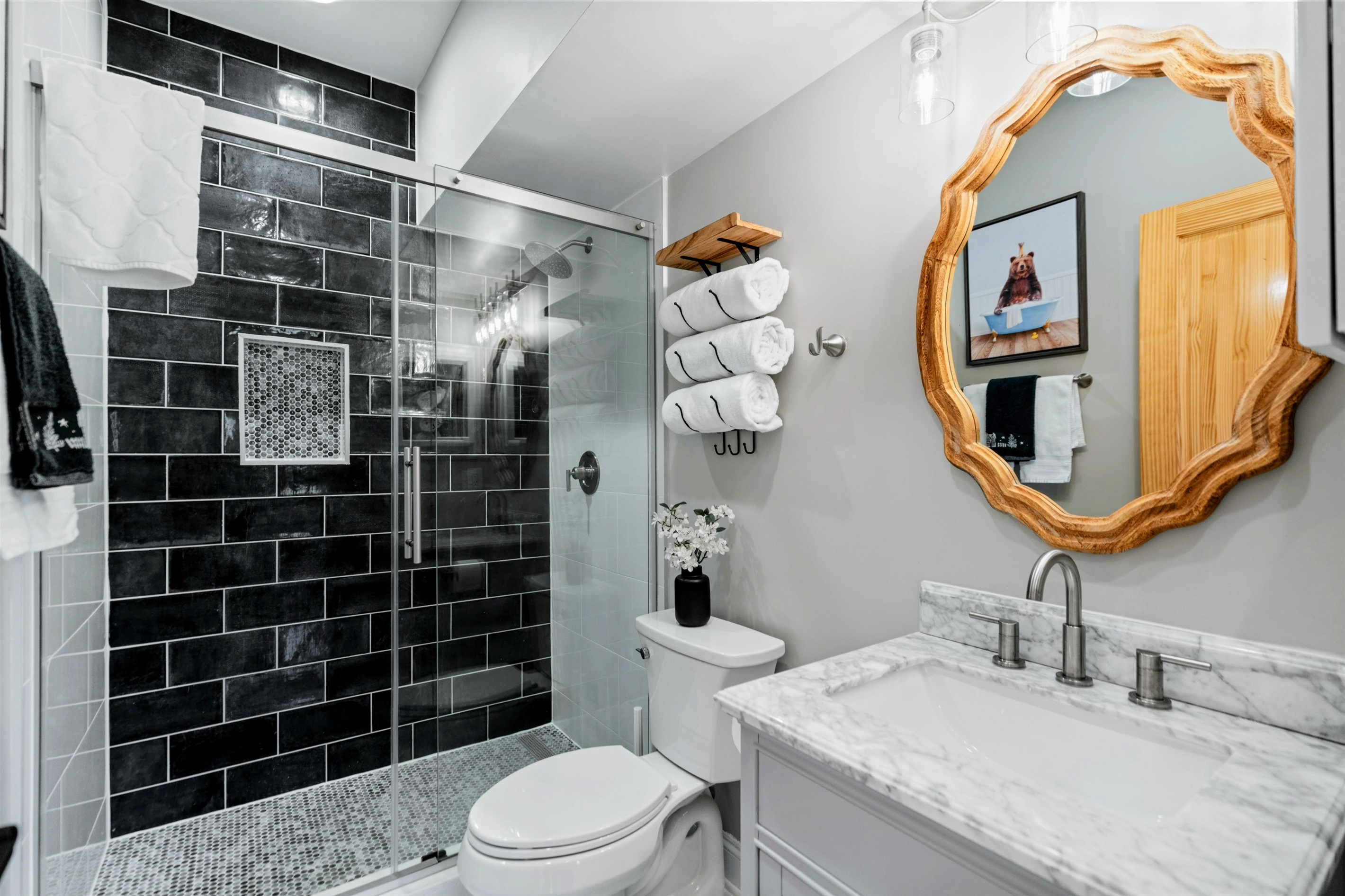 Fresh and Stylish – A sleek marble vanity, glass walk-in shower, and bold tile accents create a refreshing retreat.