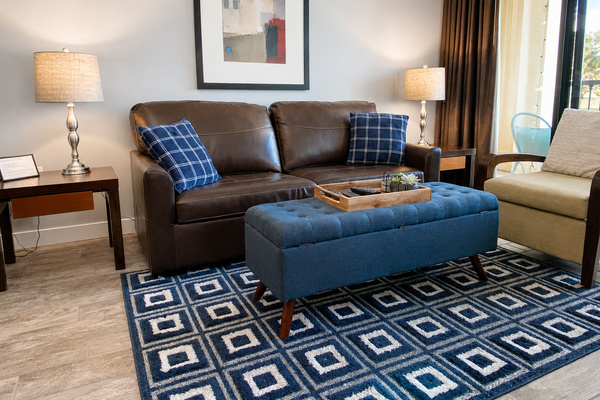 Comfortable living room with smart TV, queen sleeper sofa and balcony access.