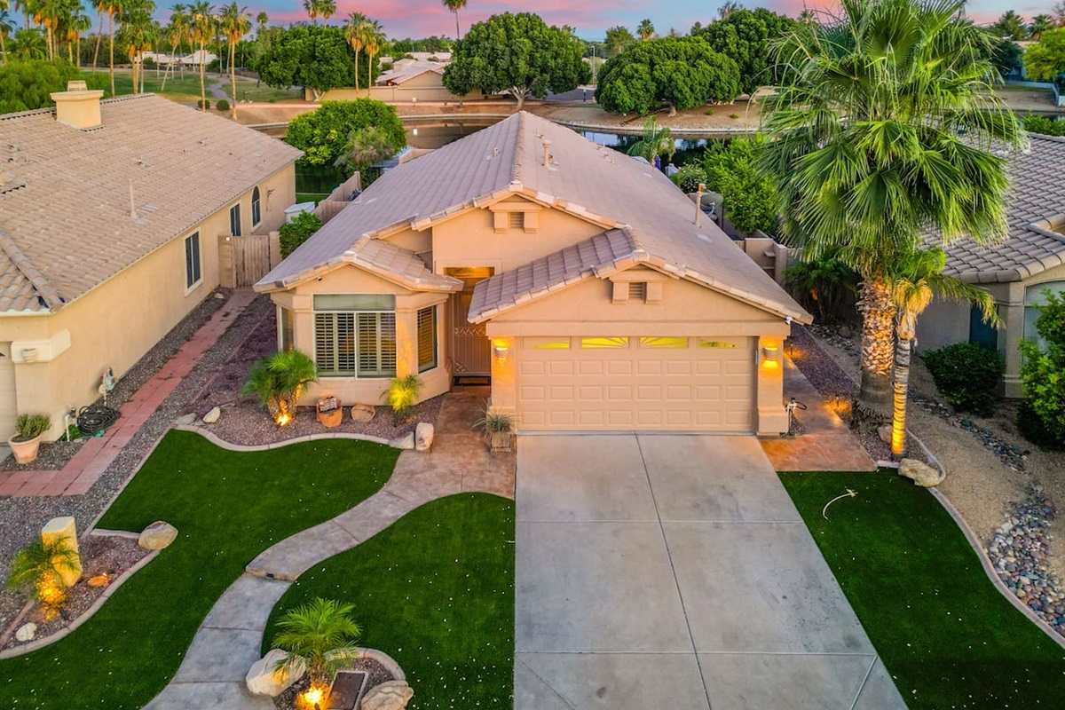 Tucked into a quiet neighborhood with palms swaying and the sky ablaze at dusk, this home immediately feels like the escape you've been looking for.