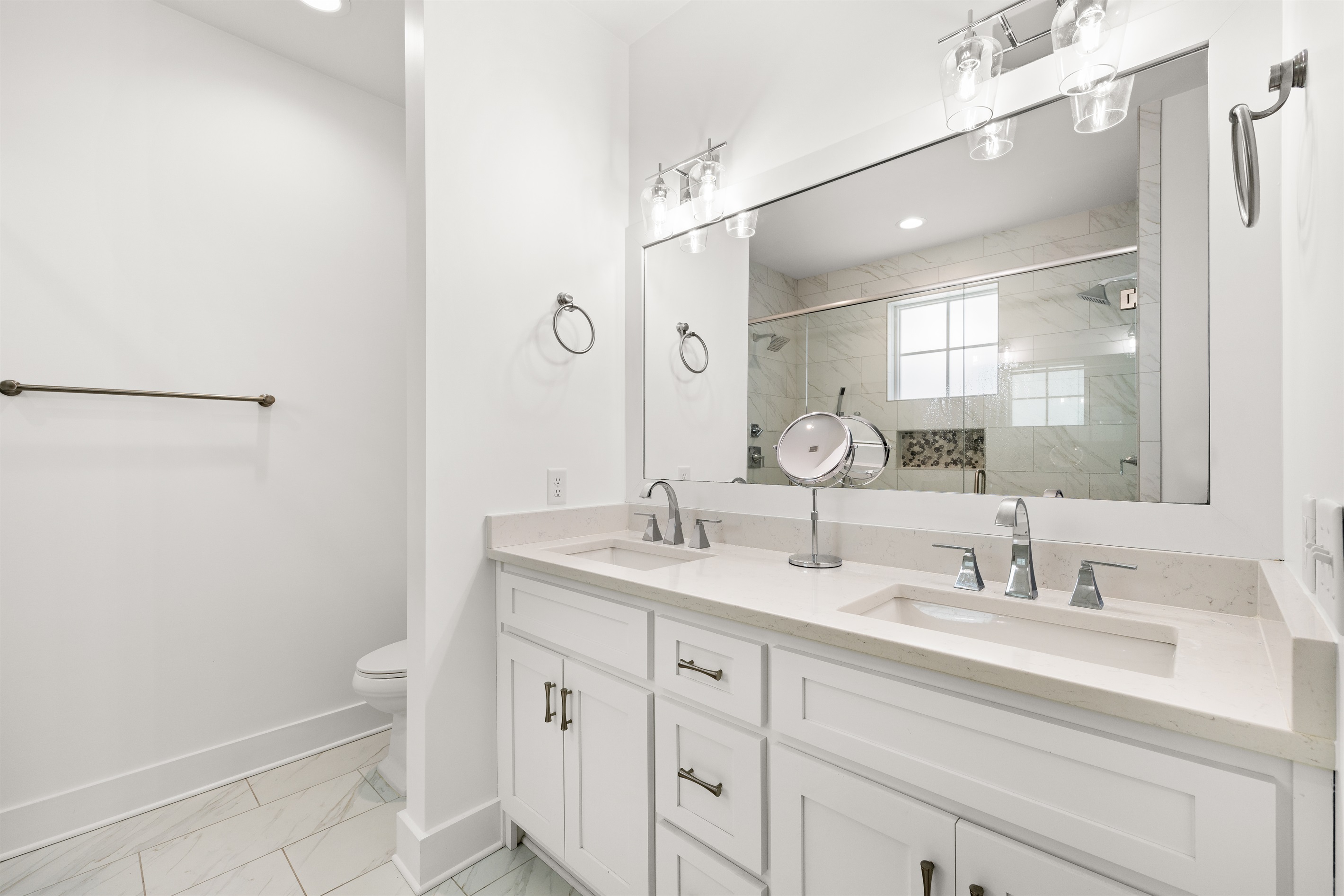 The double vanity offers added convenience, ample counter space, and a comfortable setup for multiple guests.