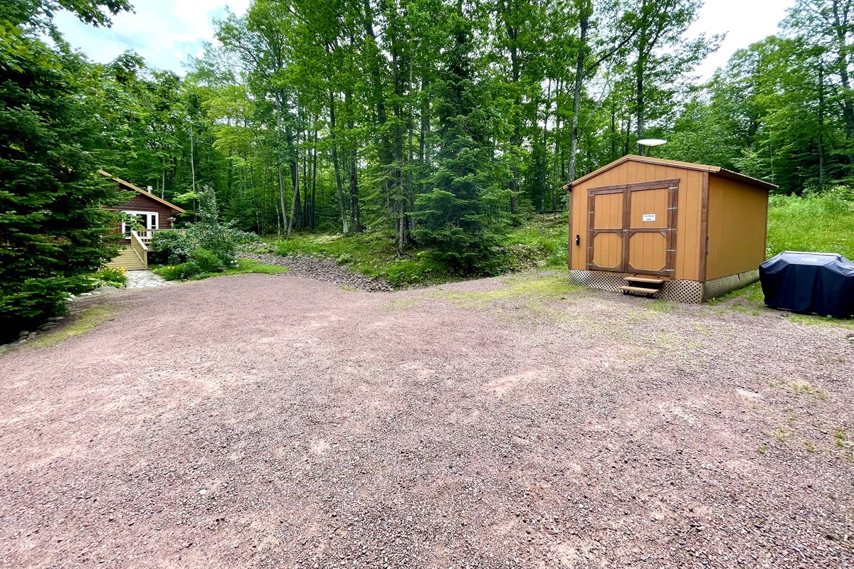 View from front door of cottage looking to driveway grill available for year-round use, the other 2nd cottage “main cottage” is 100ft away limited views pine trees and one window faces cottage with blinds for privacy 