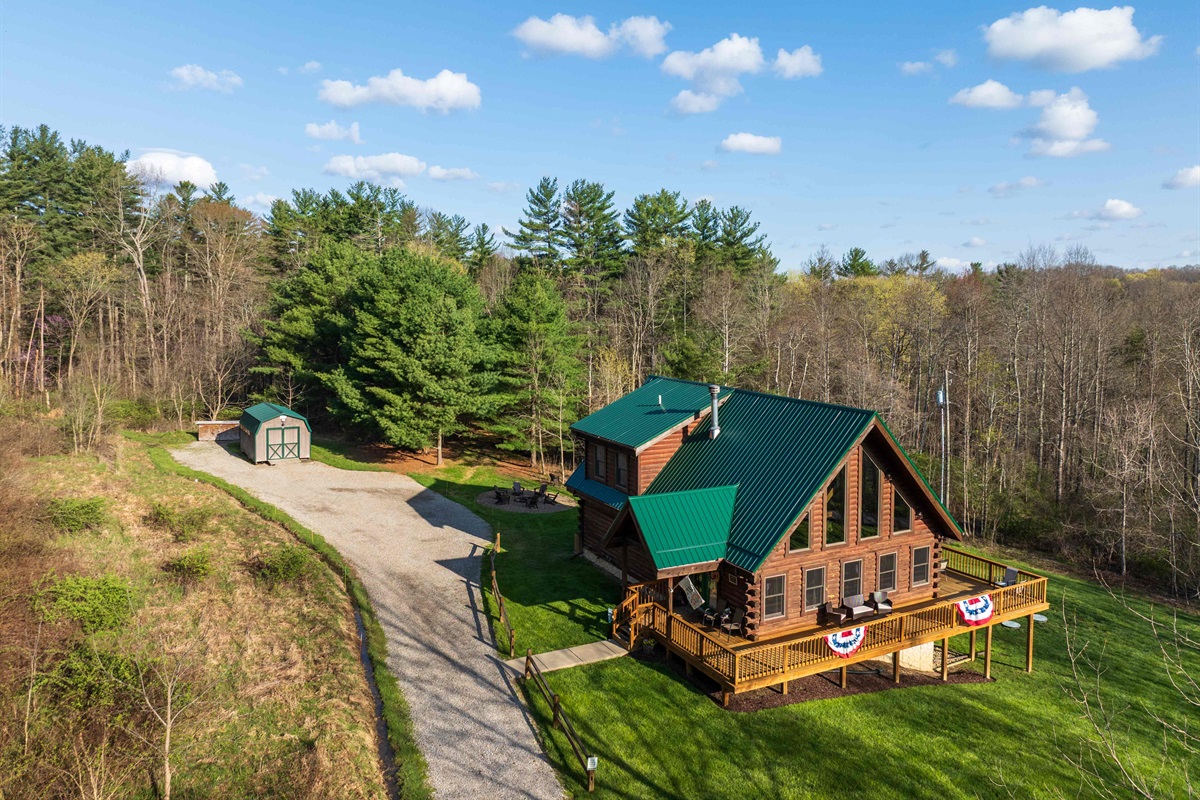 This aerial photo shows the driveway and parking area to the left of the Lodge.