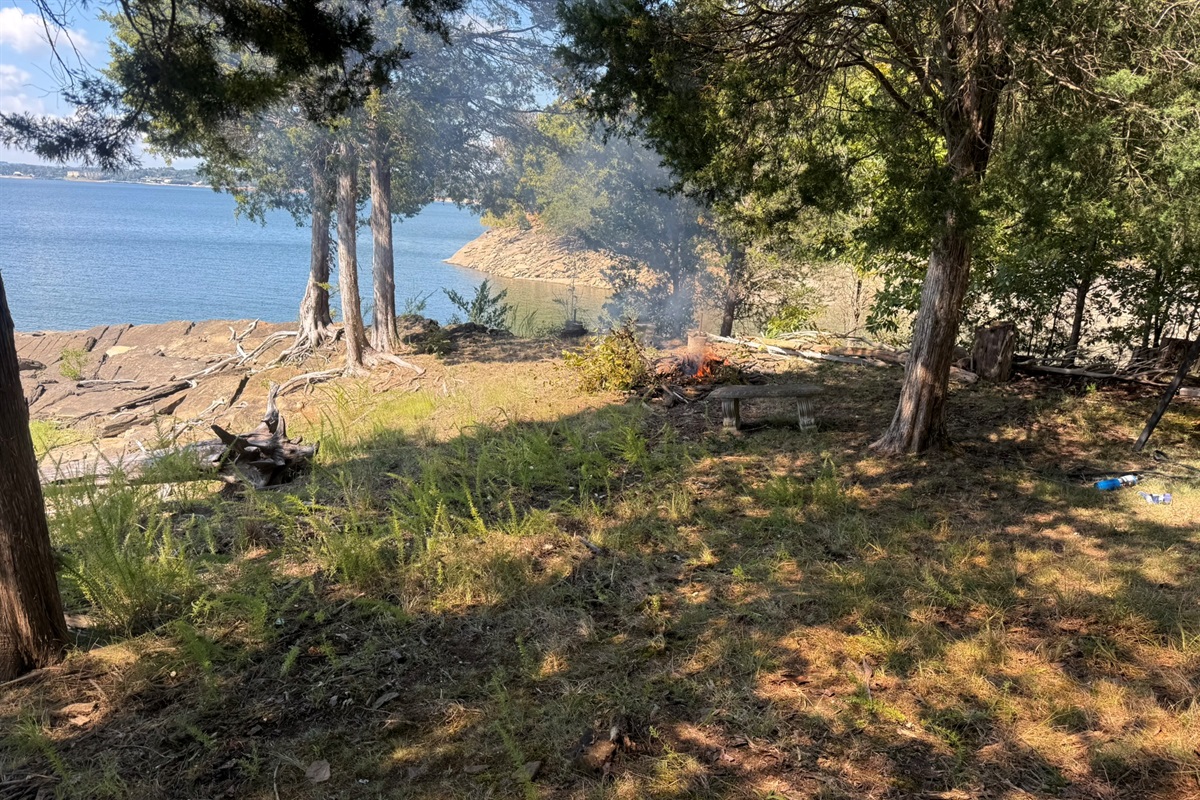 Firepit and seating area next to lake
