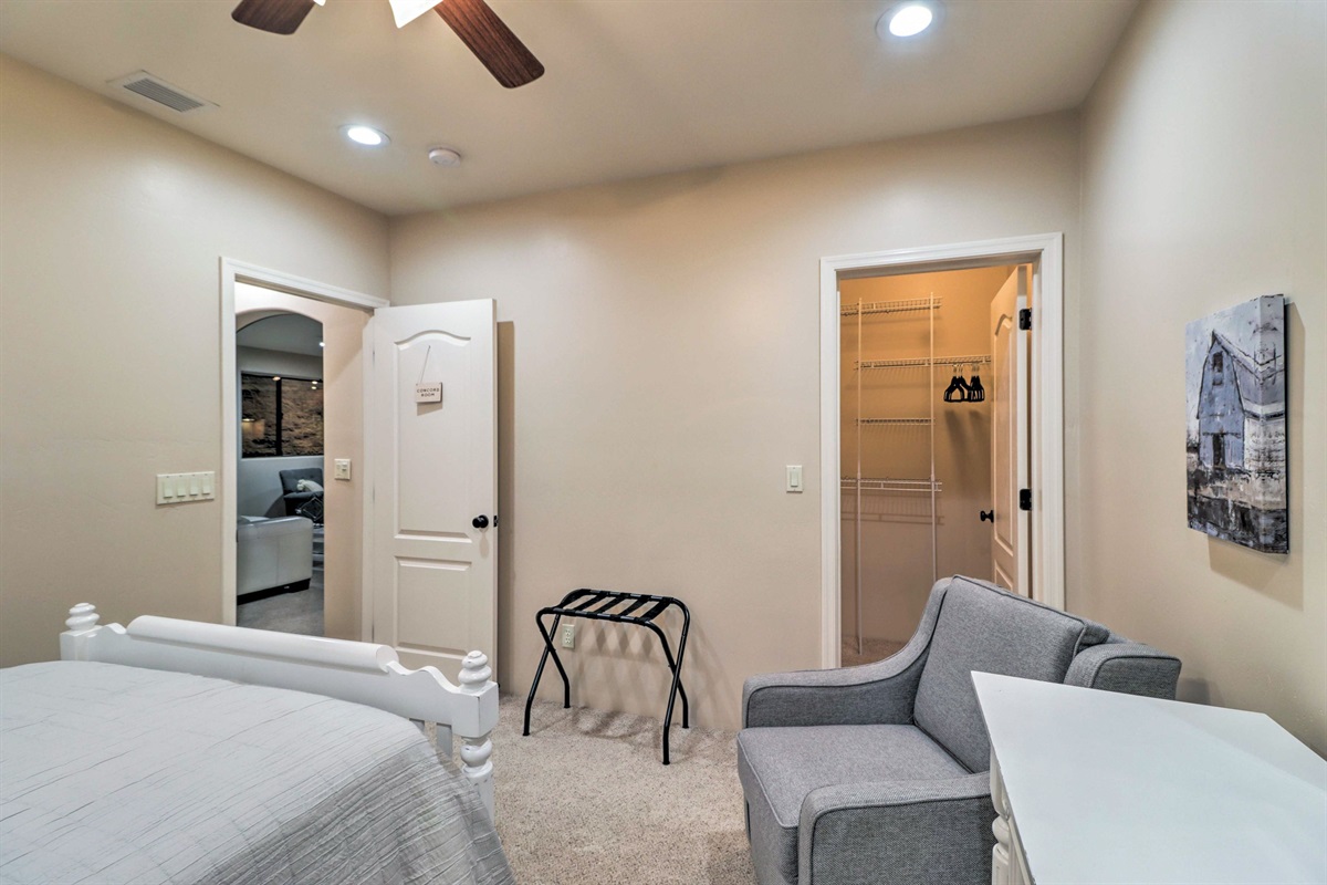 Comfortable lower-level queen bedroom with seating area and nearby bathroom access