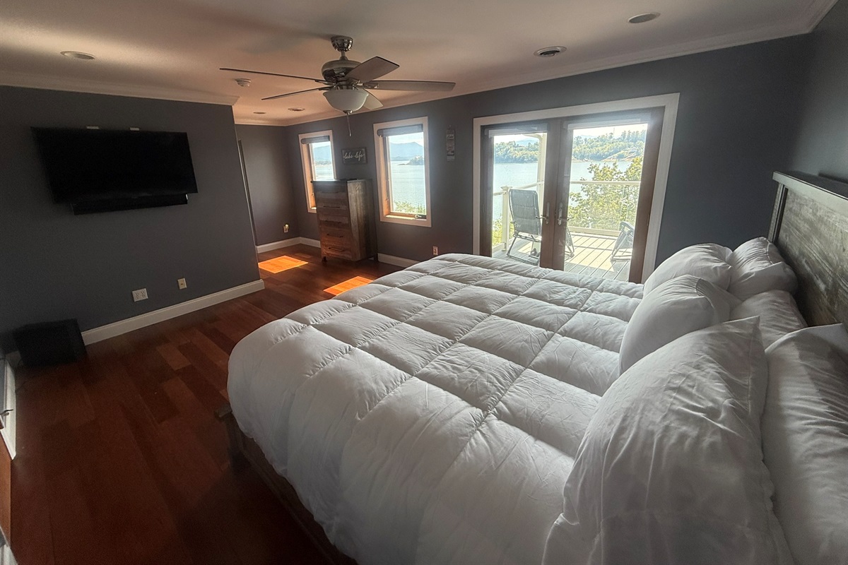 Bedroom 1 with King Bed, private covered porch, and beautiful view of Douglas Lake, Large RV, private bathroom and shower, and large closet