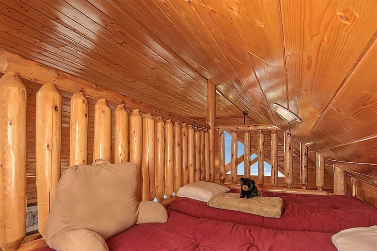 - Cozy loft nook featuring warm wooden walls and snug sleeping space   - Perfect for kids or extra guests to unwind in comfort and privacy   - Rustic charm meets mountain coziness in this intimate cabin retreat