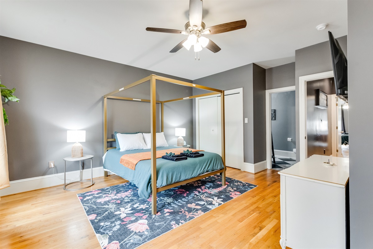 Queen Bedroom 2: Elegant design meets comfort with a chic canopy bed and vibrant decor!