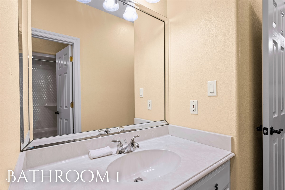 Bathroom 1 with full vanity and shower/tub combo.