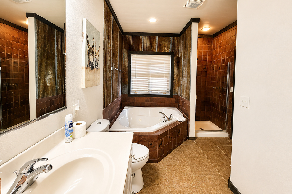 Full bathroom with a spacious vanity and corner soaking tub gives guests a comfortable place to get ready and unwind. Connected to the main floor bedroom make this convenient and easy.
