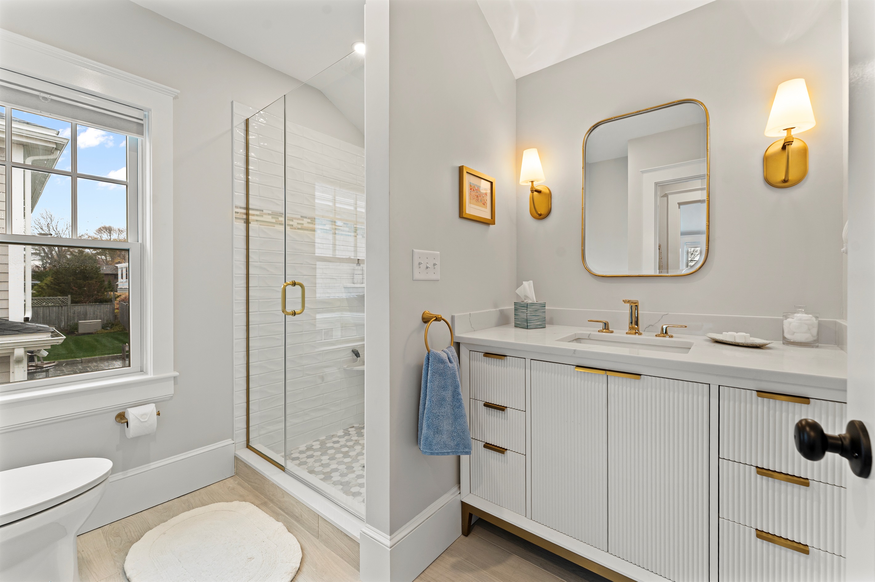 Modern full bathroom featuring a walk-in shower and toilet.