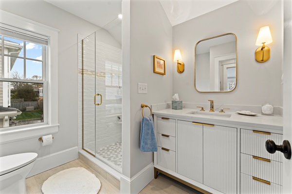 Modern full bathroom featuring a walk-in shower and toilet.