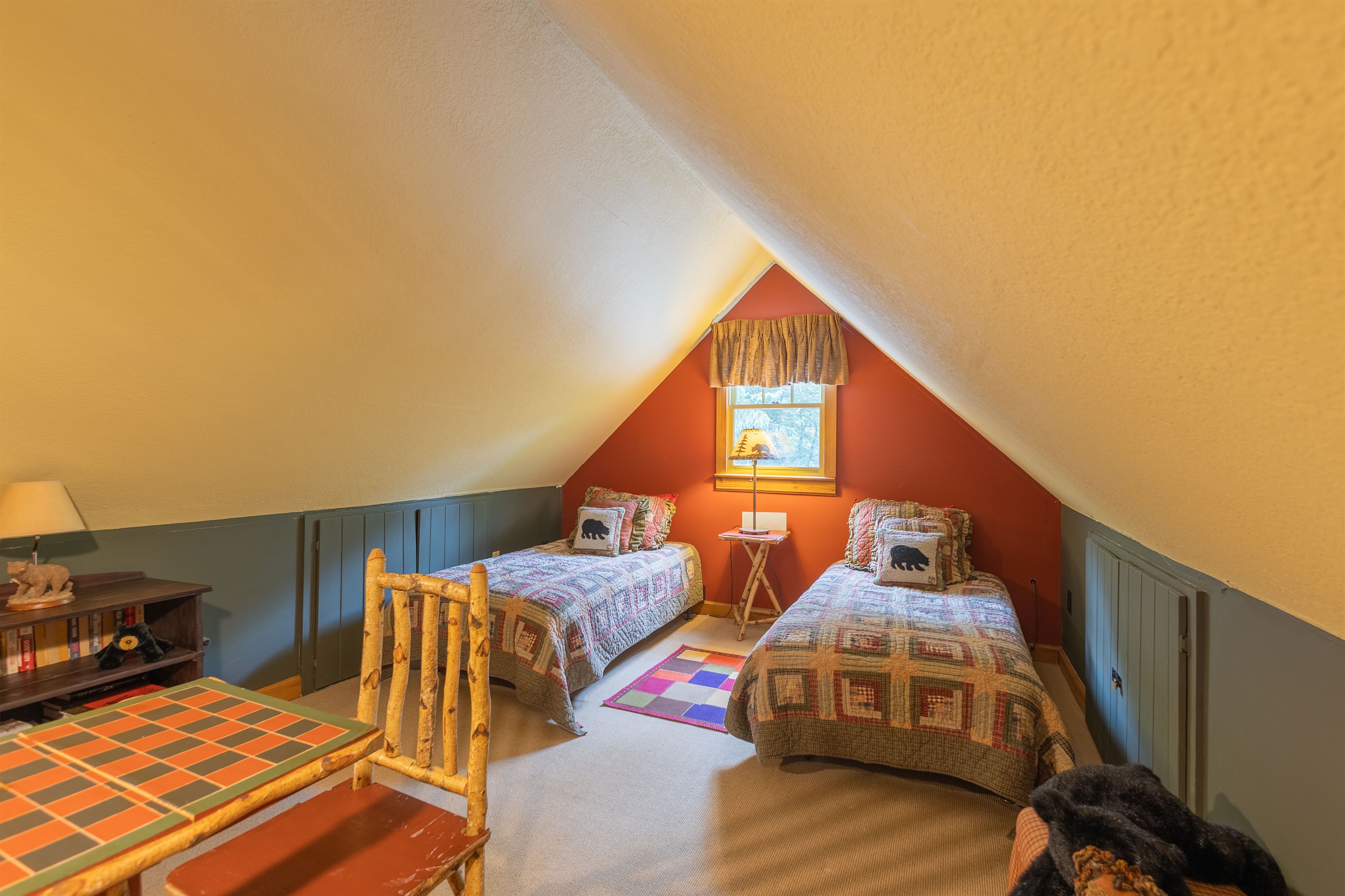 The loft combines cozy sleeping space with a small table area, creating the perfect spot for late-night games, snacks, or winding down after a day outdoors.