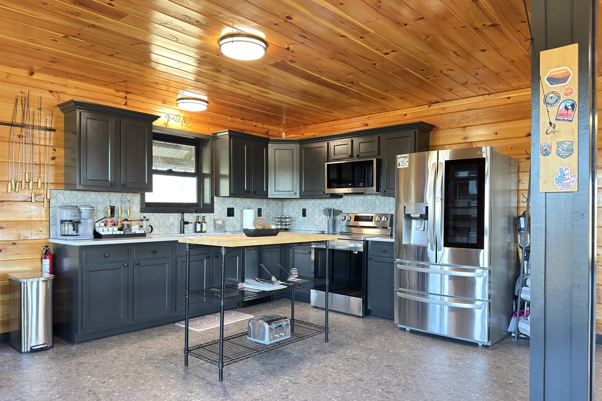 Newly renovated kitchen with new quartz counters, backsplash, and black sink.