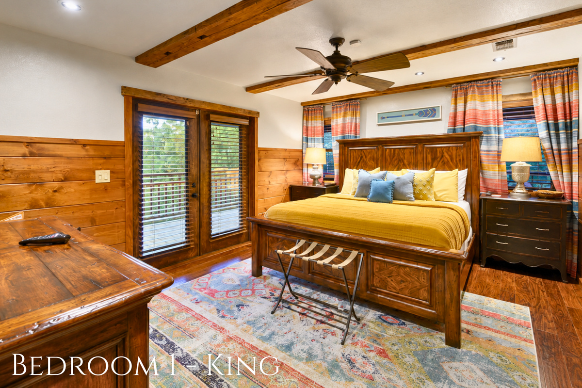 Warm wood walls and colorful cabin details give this king retreat a cozy personality, with direct outdoor access just steps from the bed.