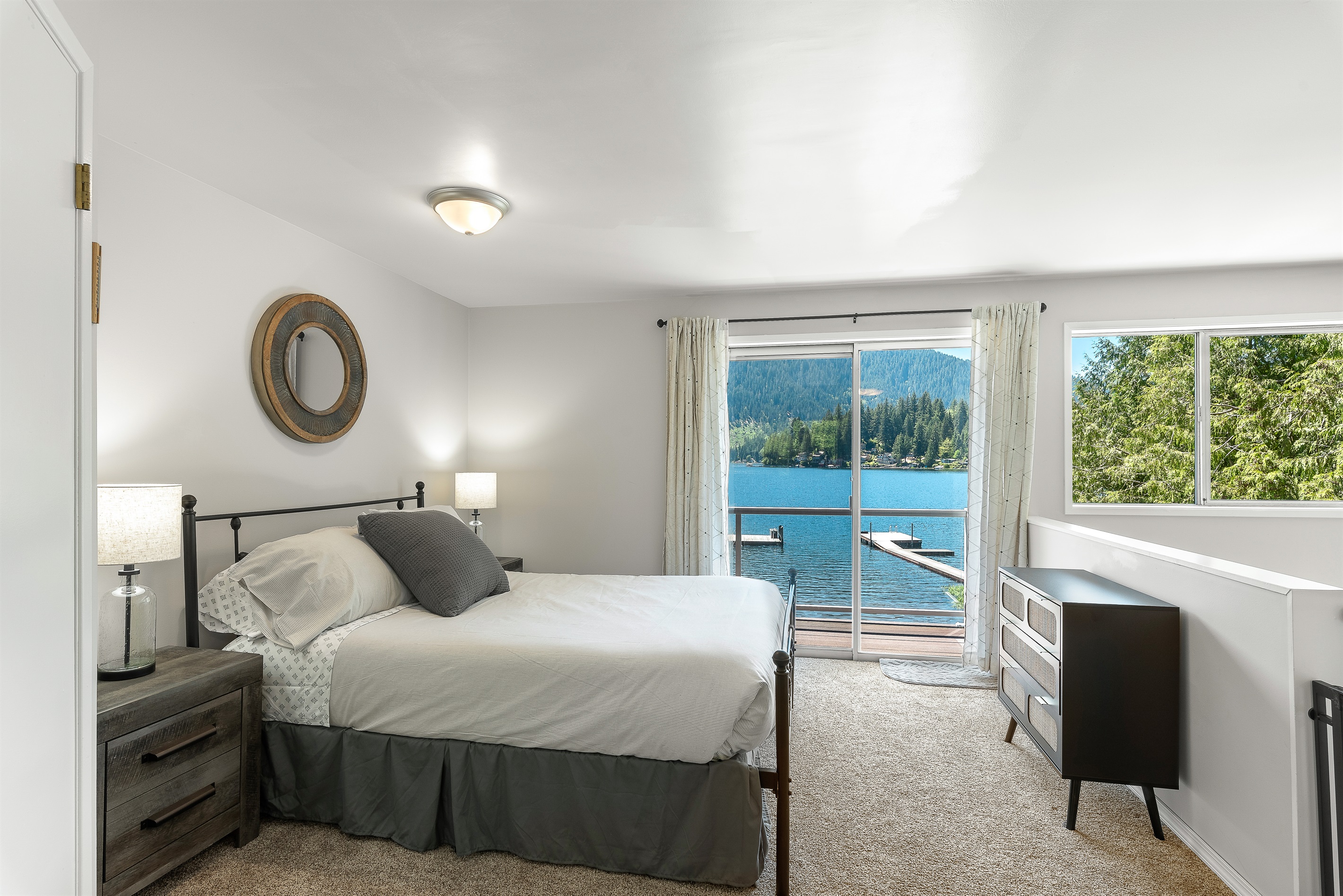 Upper level queen bed with sliding door to the upper balcony.