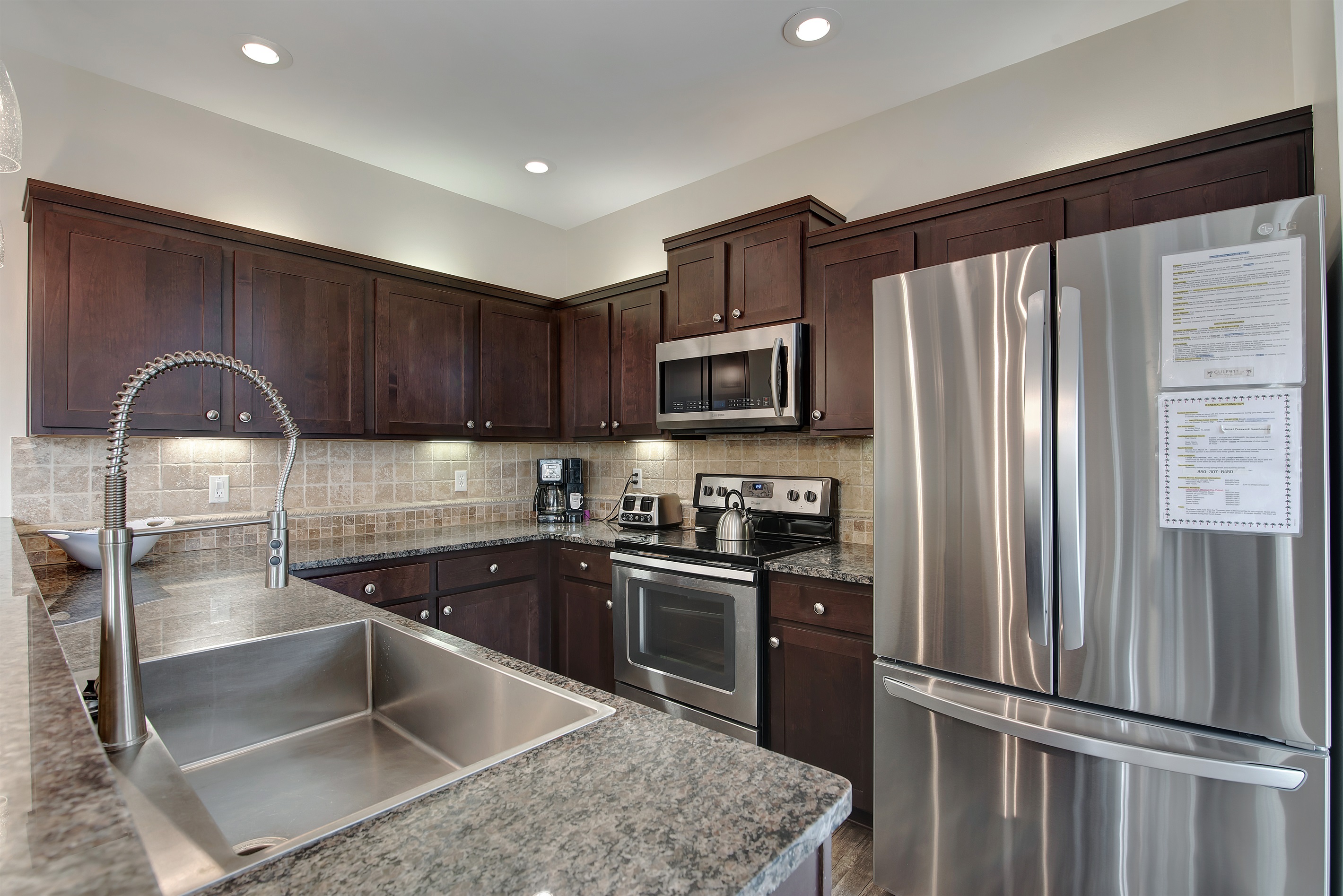 Modern kitchen with stainless‑steel appliances and granite countertops